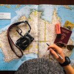 Solo Travel Tips for Beginners cover with a solo traveler, backpack, map, and sunrise train platform