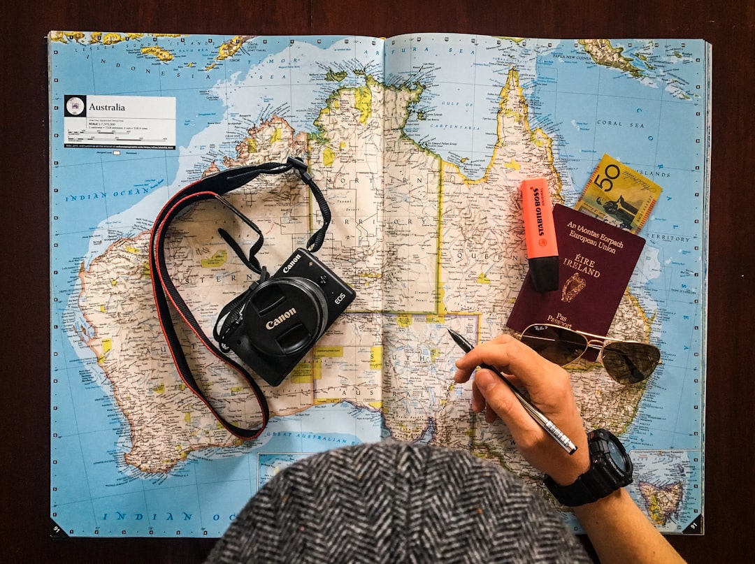 Solo Travel Tips for Beginners cover with a solo traveler, backpack, map, and sunrise train platform