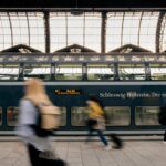 Slow travel in Europe cover image showing a rail line, a café table, and layered city rooftops