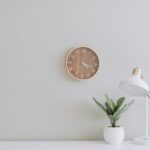 Illustration of a mindful productivity system on a clean desk with a journal, clock, and tea