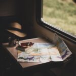 Cover art visualizing travel itinerary planning with route lines, calendar blocks, and a suitcase