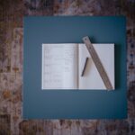 Sketch desk scene with notebook, map, rail ticket, and pencil for Slow Travel Itinerary Planning